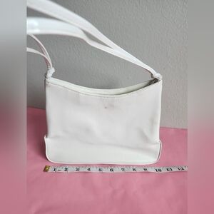 White shoulder bag features a minimalist,  double-strand leather strap 10.5x7.5